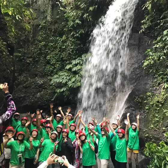Large group at a jungle waterfall