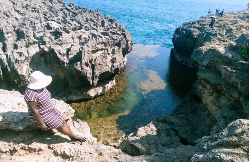 Guest at Broken Beach rock arch, Nusa Penida