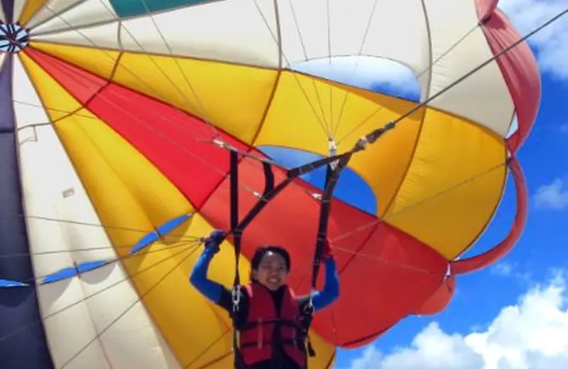 Guest parasailing above the beach in Nusa Dua